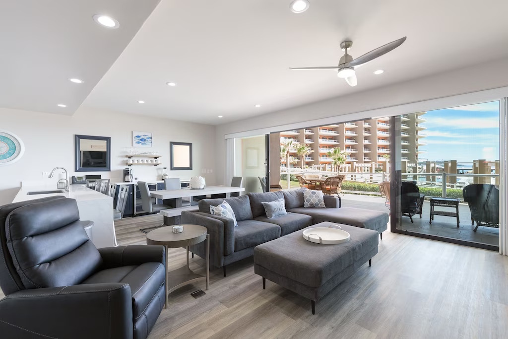 View of the spacious living/dining room and the condo complex and slight ocean view out the window. 