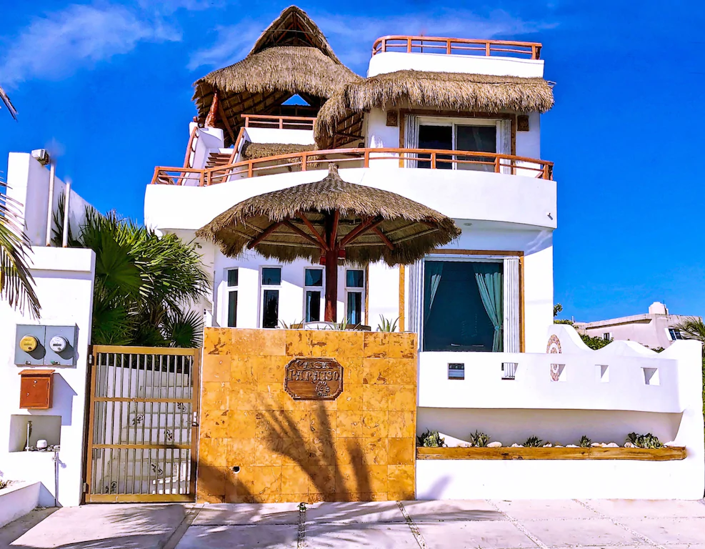 View of the three story Isla Mujeres House with rooftop hangout area. 