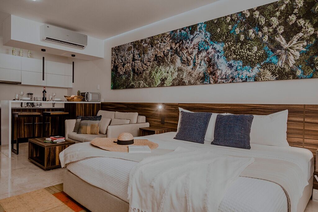 View of the comfortable bedroom and impressive wall art of the Infinity Pool studio.