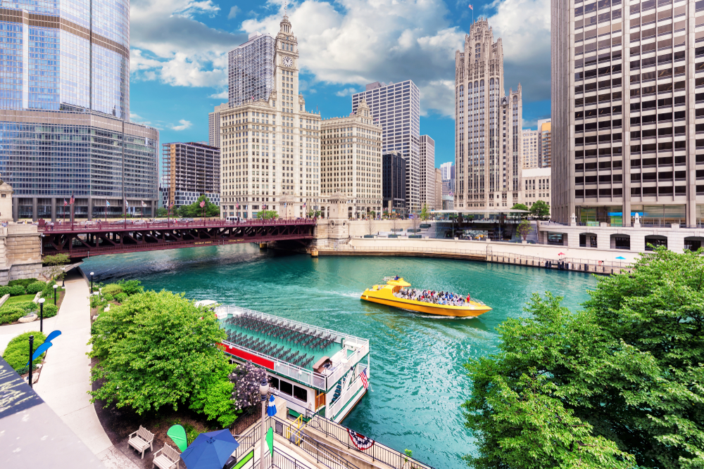 Chicago lake with a taxi boat and big buildings in the back. this is one of the best summer vacations in the USA 