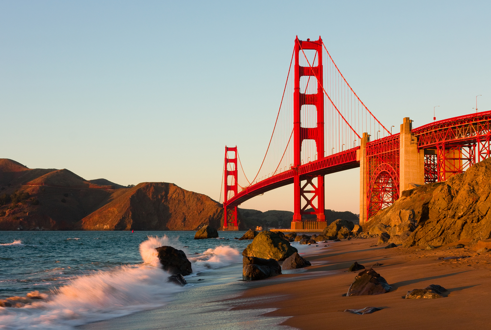 Golden hour over the Golden Gate Bridge as viewed from the beach below it.