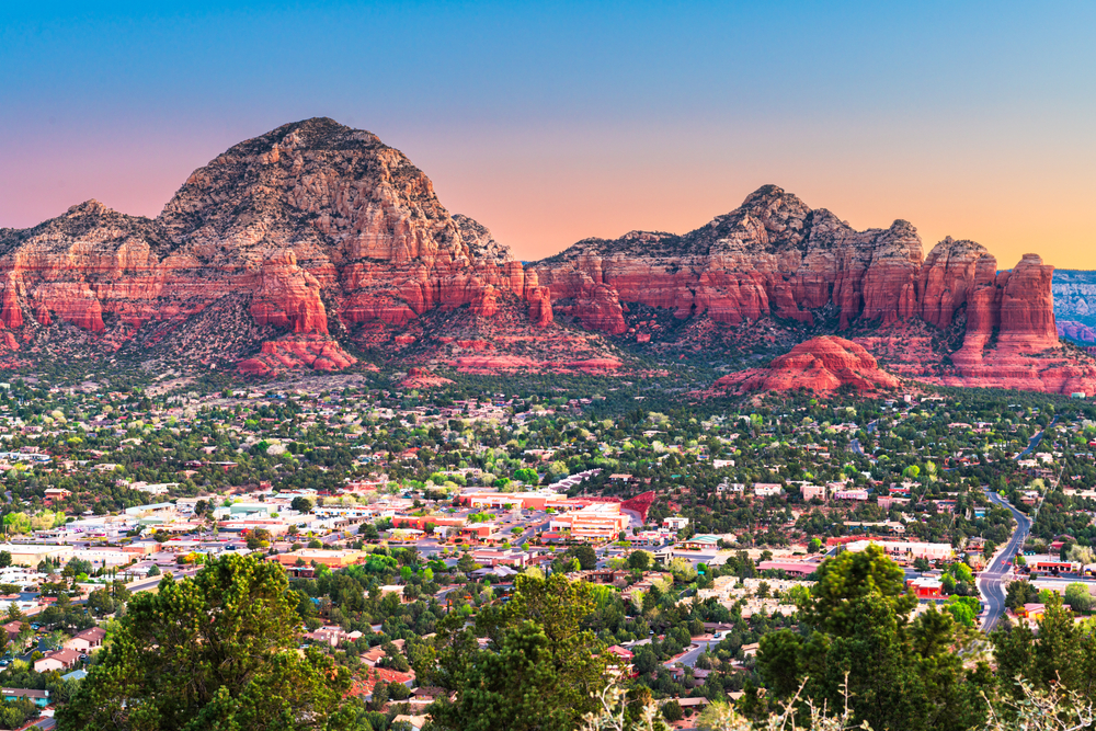 Downtown cityscape and mountains in an article about where to stay in Sedona.