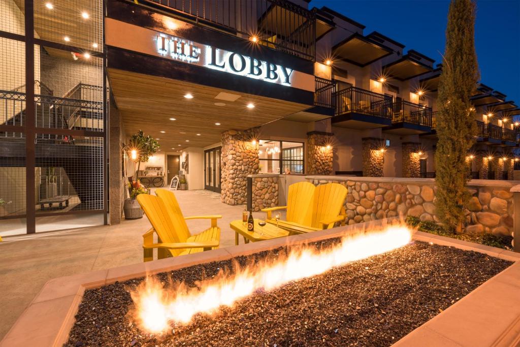 Outsidie the lobby of The Tavern with two yellow chairs around a firepit. This is where to stay in Sedona  