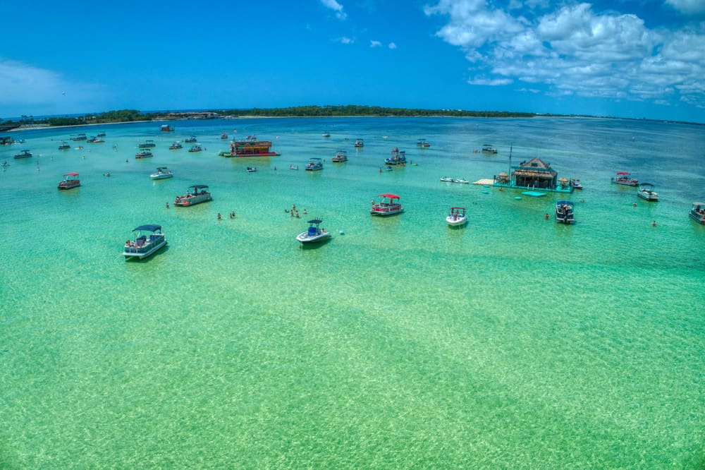 The sandbar at Crab Island in Destin filled with boats, and floating restaurants
