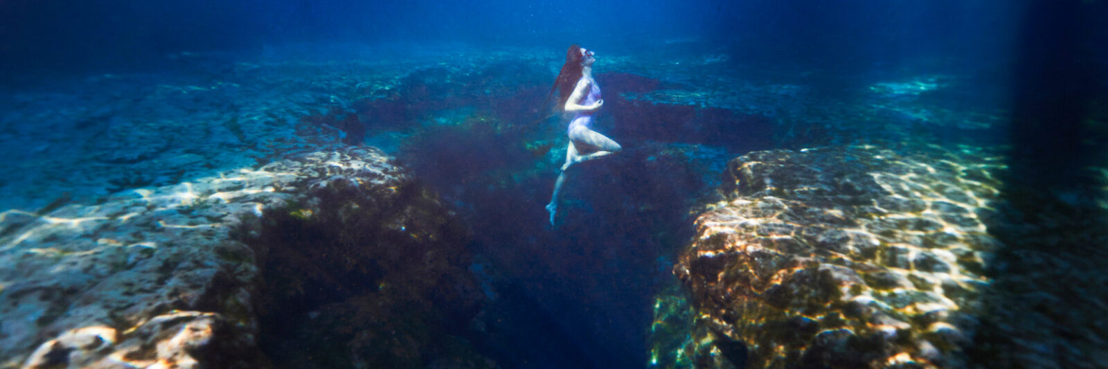a girl underwater in the springs