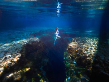 a girl underwater in the springs