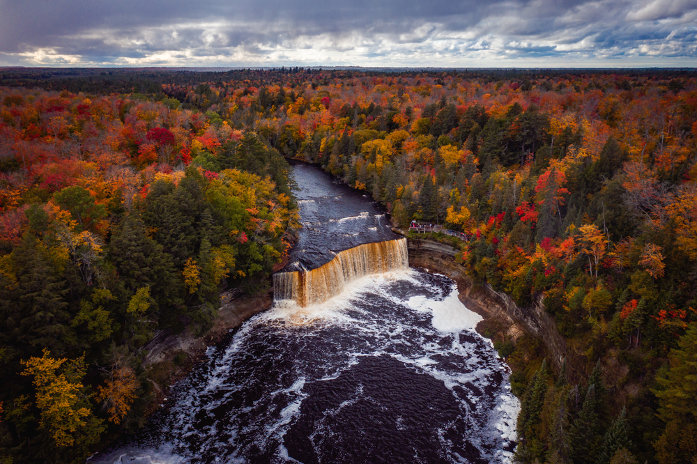 Aerial view of Tahquamenon Falls surrounded by fall foliage in the Upper Peninsula.