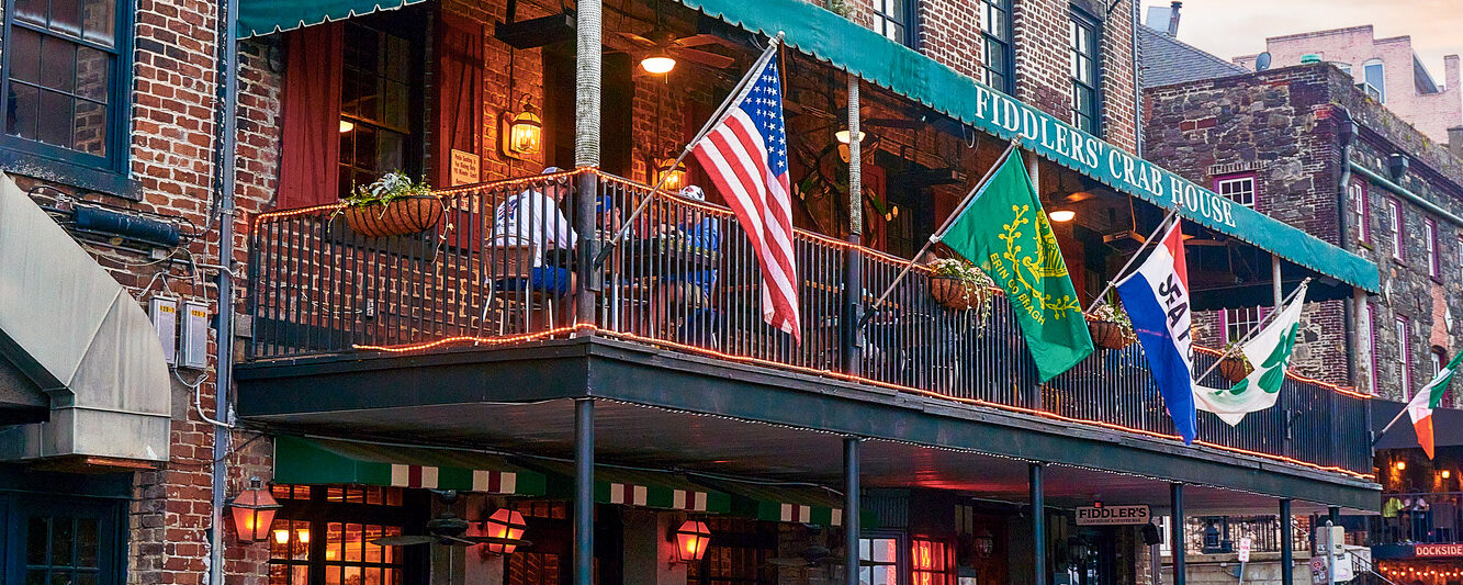 a girl in a blue dress standing in front of the riveer in Savannah GA