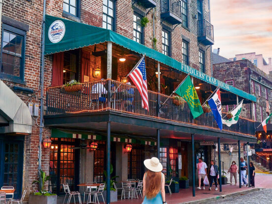 a girl in a blue dress standing in front of the riveer in Savannah GA