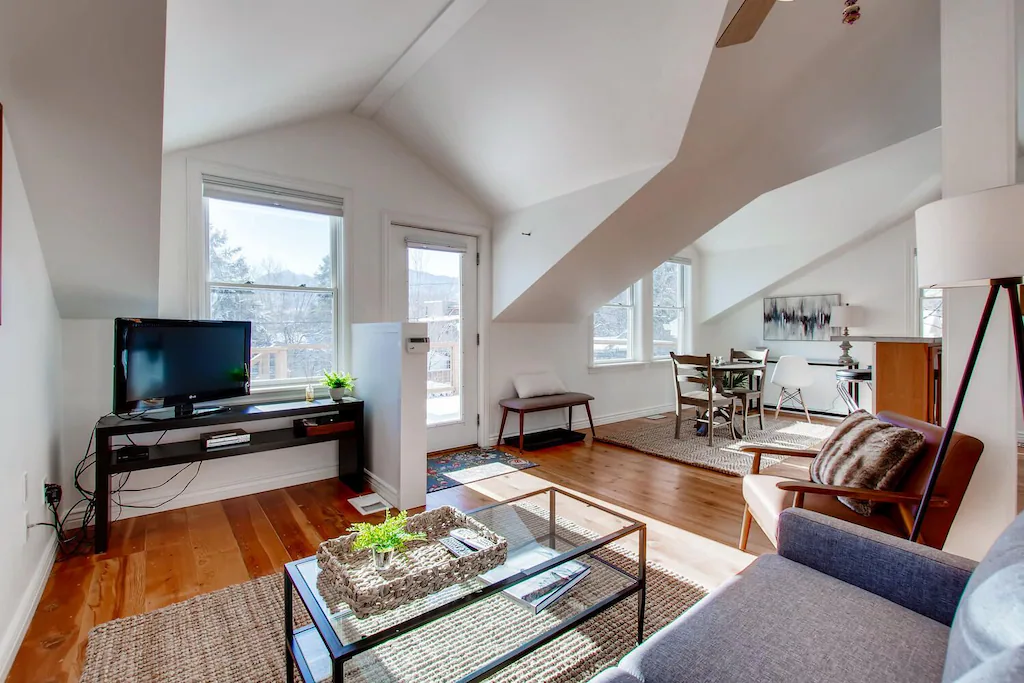 View of the light and bright interior of the Boulder Carriage house. It has very high ceilings.