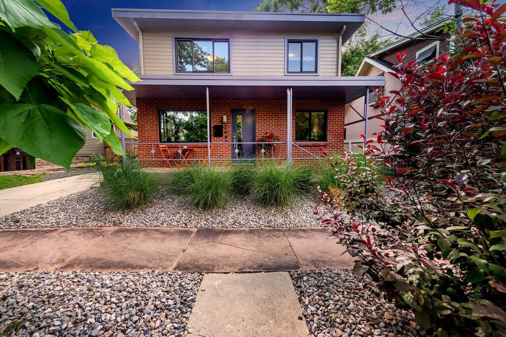 View of the modern brick exterior and tree lined street of the Modern Mapleton home.