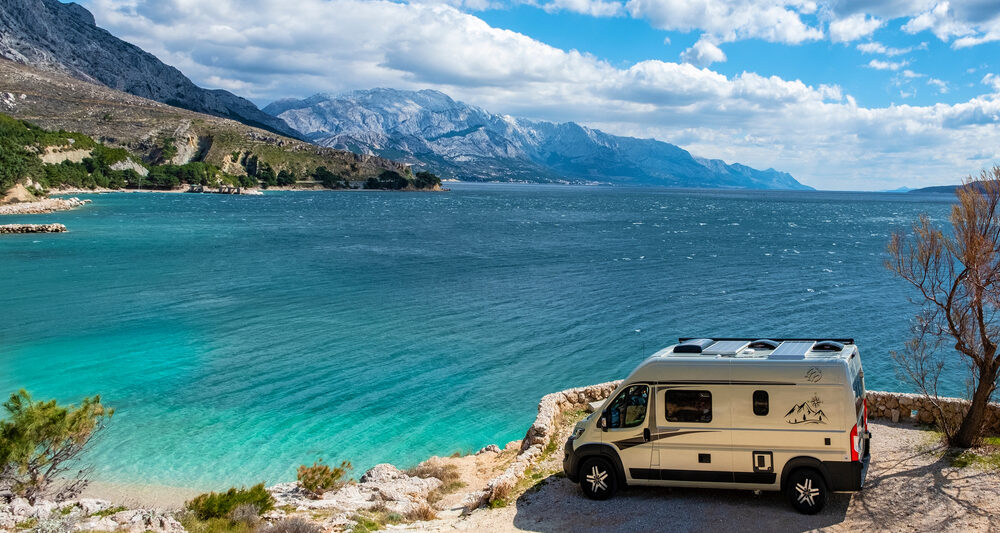 photo of an RV with mountains int he background at one of the best beach campgrounds in the USA