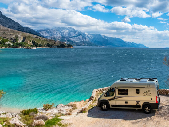 photo of an RV with mountains int he background at one of the best beach campgrounds in the USA