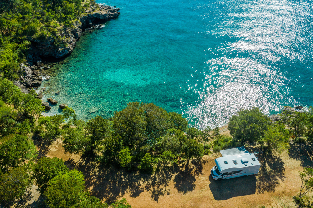 An RV sits on the coast overlooking the beach at one of options for best beach camping in the USA.