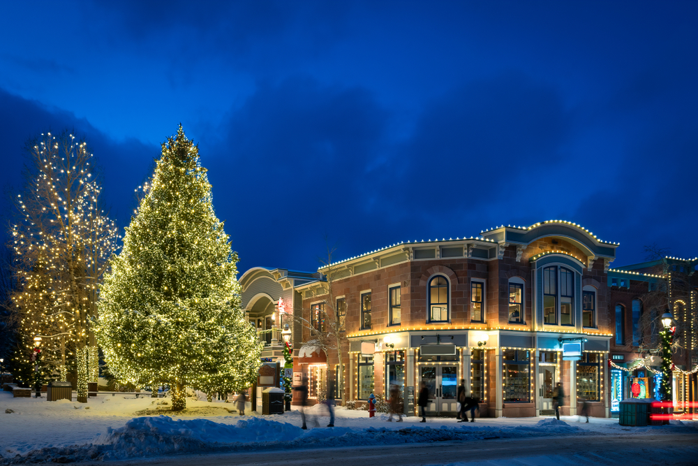 the town of Durango Colorado with big trees and pretty lights with snow on the ground. This is one of the best christmas towns in the USA 