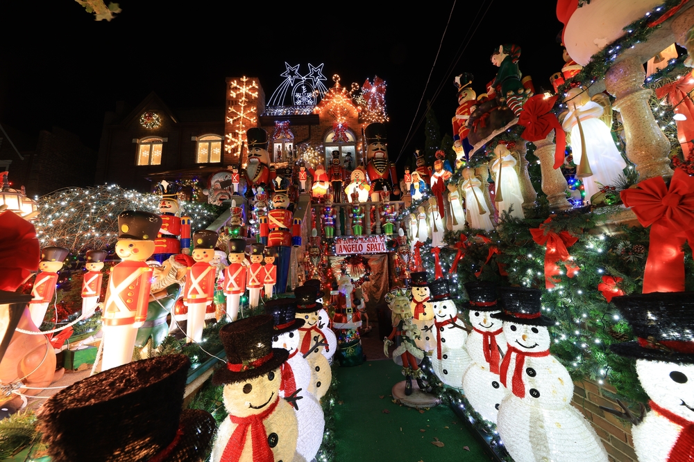 a big house in the Dyker Heights neighborhood in Brooklyn with so many Santas, lights, and snowmen all lined up perfectly 