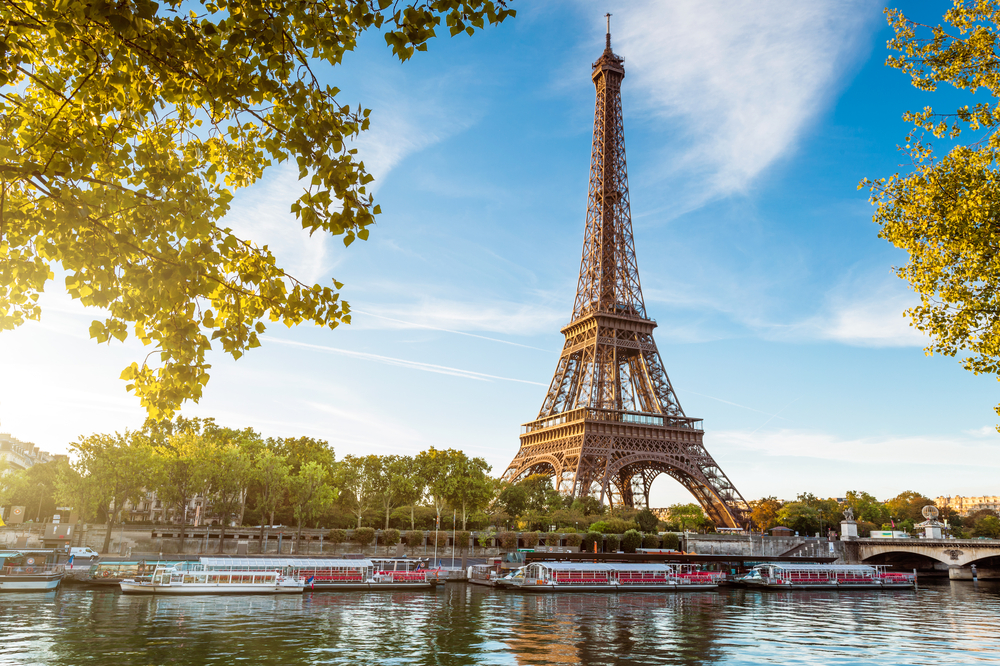 The Eiffel Tower viewed across the river during golden hour.
