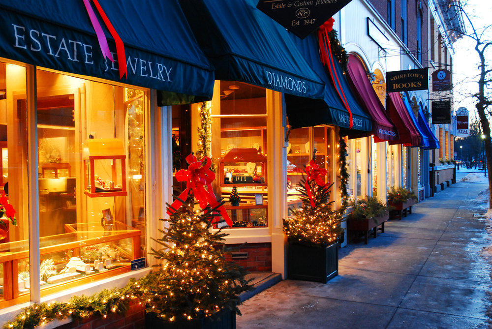a pretty store front in Woodstock, VT with small trees lights and bows
