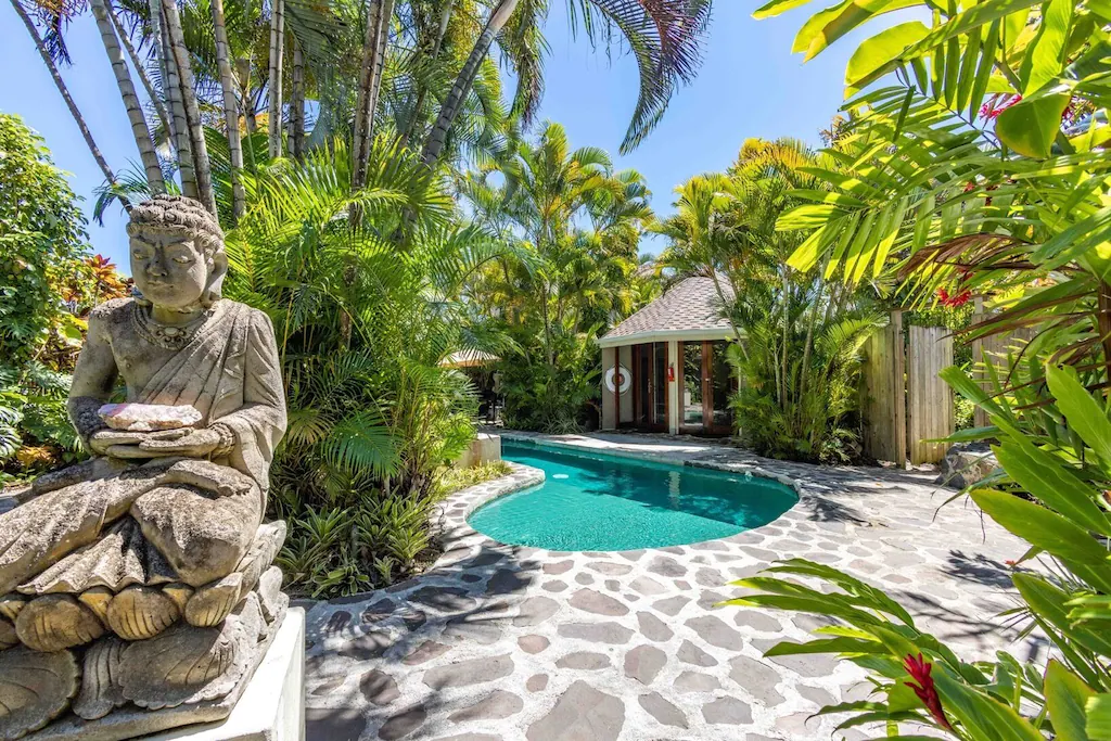 View of a Buddha statue by the pool at the Cliff House