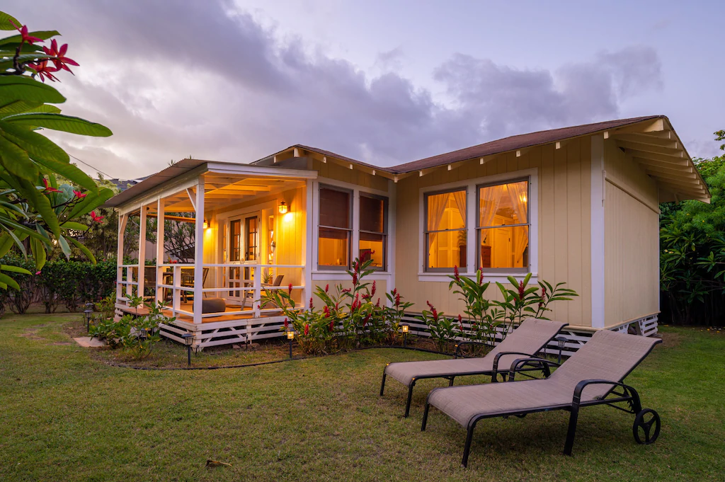 View of the buttery yellow exterior and cute front porch of the Nene Nest Cottage 