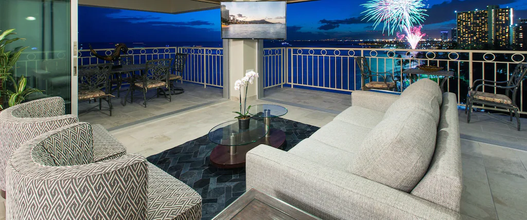 View of fireworks over Waikiki Bay from the floor to ceiling windows of this epci Airbnb in Hawaii