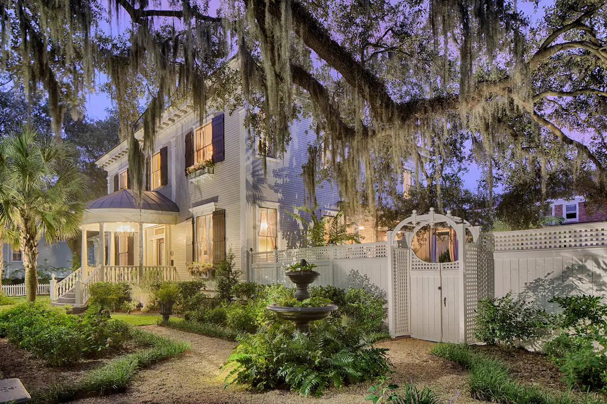 Exterior shot of a Southern Mansion surrounded by oak trees and Spanish moss 