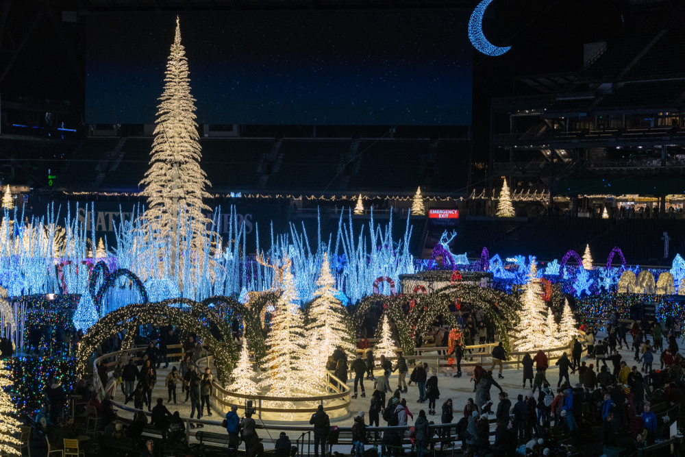 Holiday display with lit trees and ice skaters in Seattle.