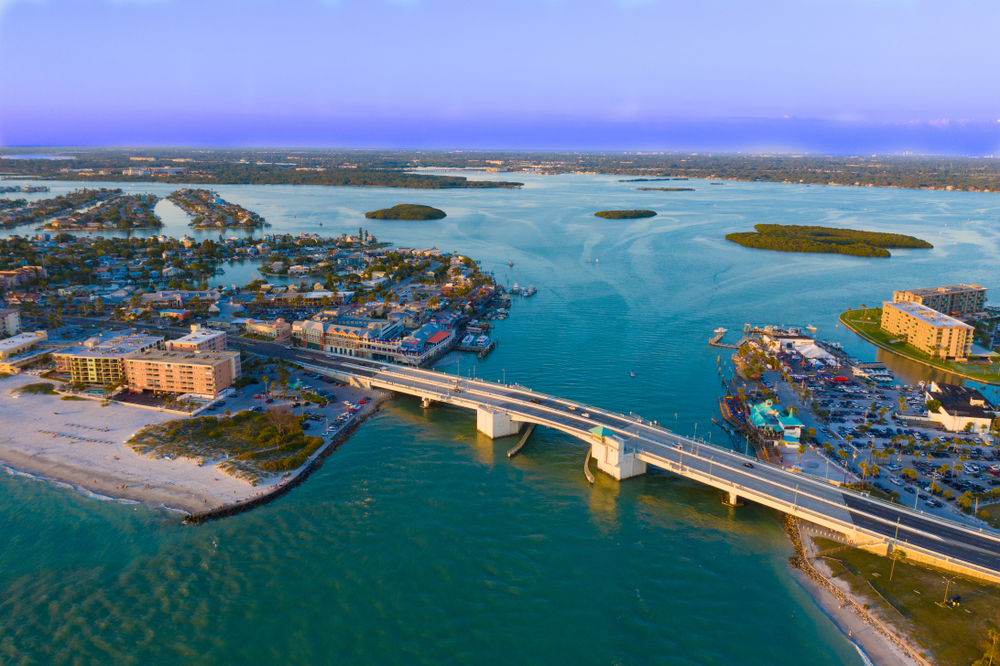 An arial shot of John's Pass shows a boardwalk, the inland beach, and tons of hotels and shopping opportunities. 