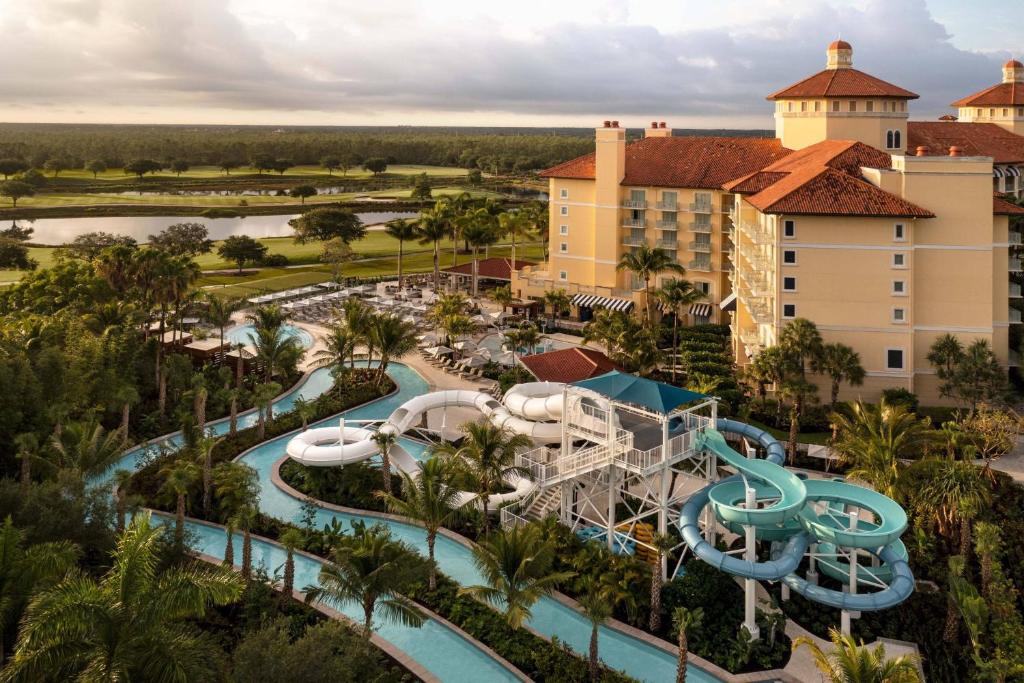 3 winding slides and a lazy river with the property in the background at the Ritz Naples