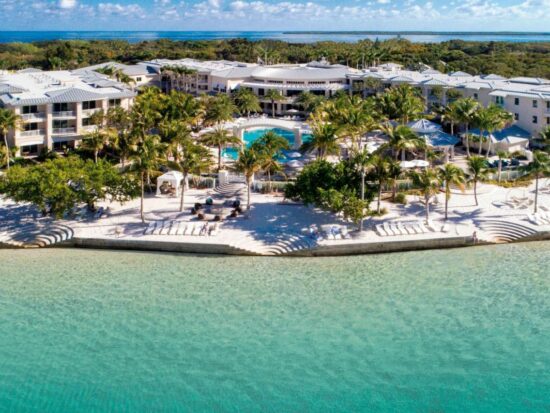the playa largo resort and spa in the Florida Keys. it is right on the beach front with beautiful clear waters, plenty of palm trees, and lounge chairs in the back