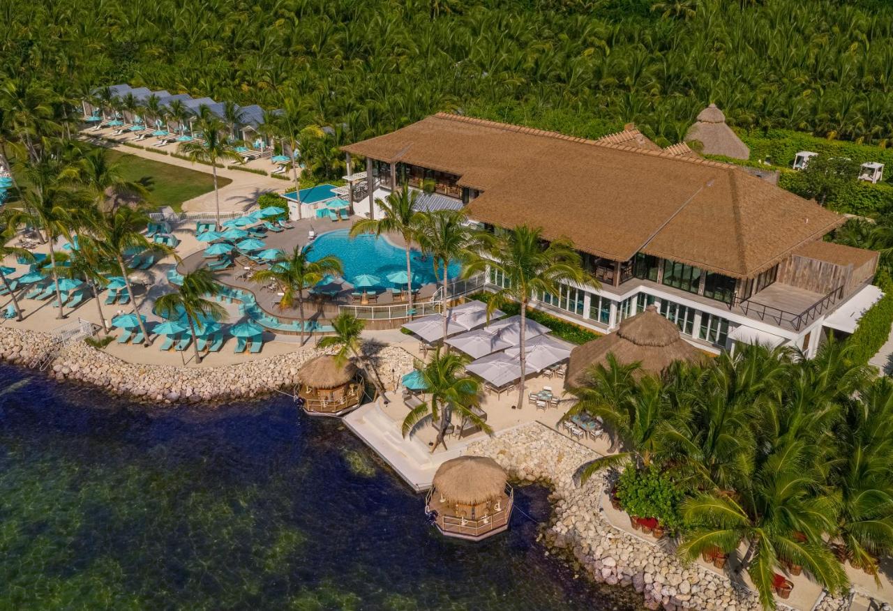a beautiful view of the bungalow key largo resort from above. with beach chairs and pool, and beautiful waters. this is one of the best resorts in the Florida Keys 