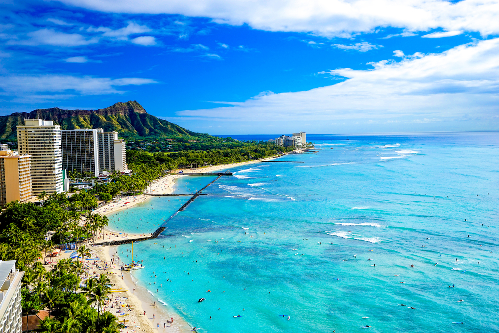 An aerial view of the Oahu coastline near Waikiki Beach on a sunny day