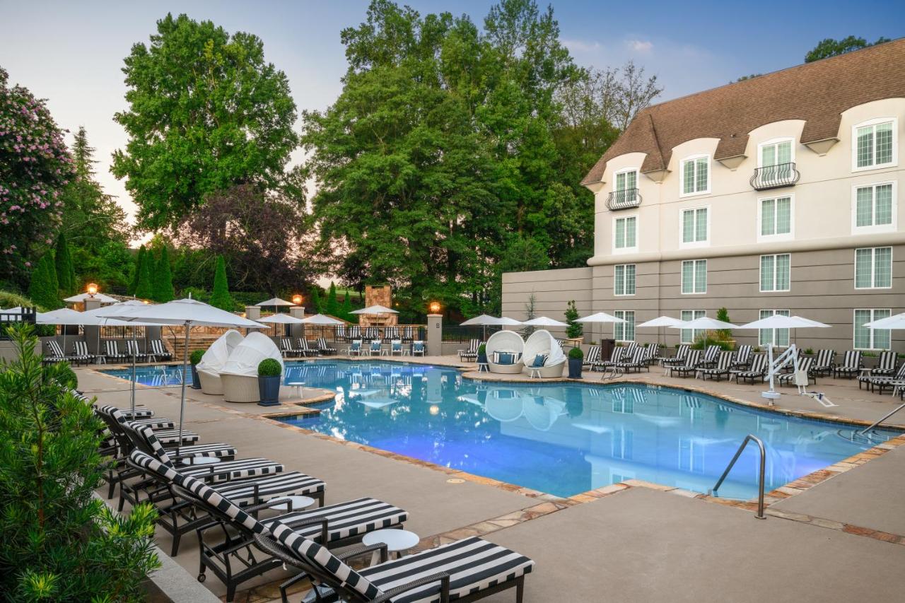 a large pool with private seating bubbles as well as a beach chairs at the back of the property of this lovely resort!