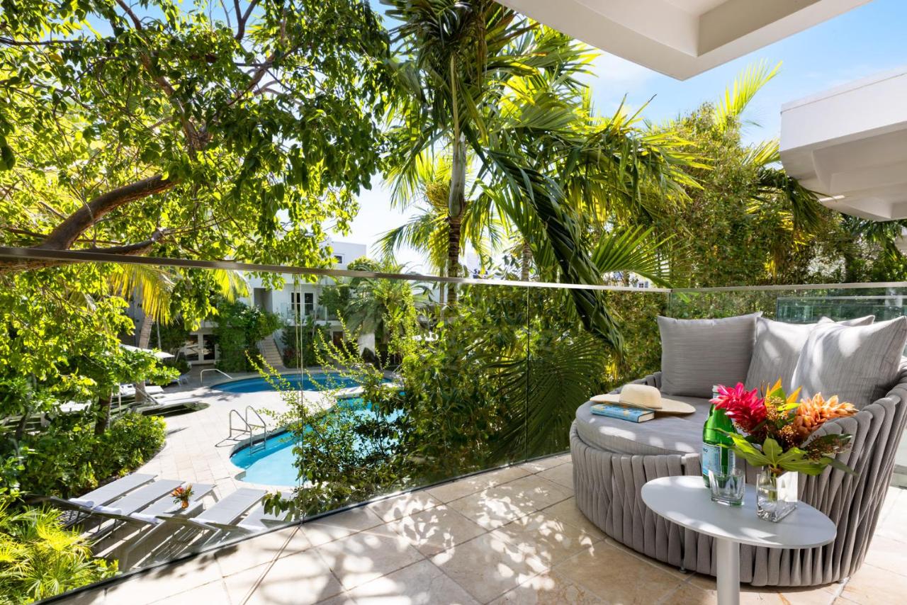 the view from one of the best resorts in the Florida Keys with a big chair and beautiful blue pool surrounded by the gardens. 