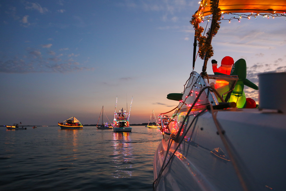 Five boats decorated in Christmas lights and decor for the Christmas Boat Parade, a fun thing to do for Christmas in Florida.