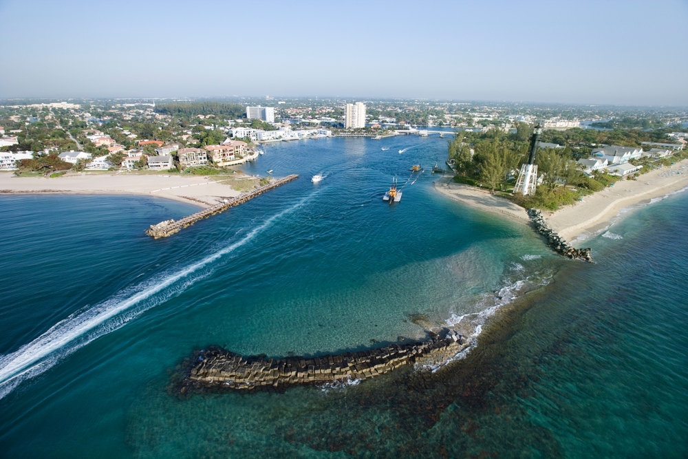 the view of Playa Linda inlet with hotels, rocks, and beautiful blue waters this is one of the best beaches near Orlando FL 