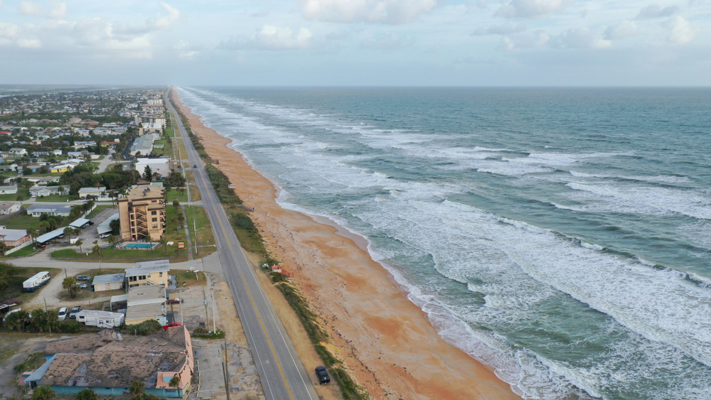 one of the best beaches near Orlando Fl with big waves rushing in and a few beach homes and hotels along the shore.