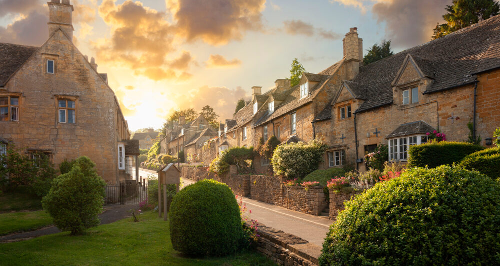 sunset over beautiful houses in the cotswolds in england