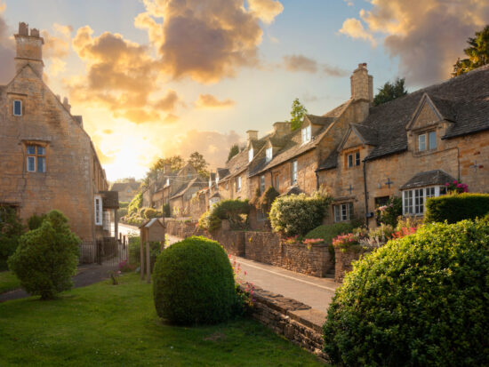 sunset over beautiful houses in the cotswolds in england