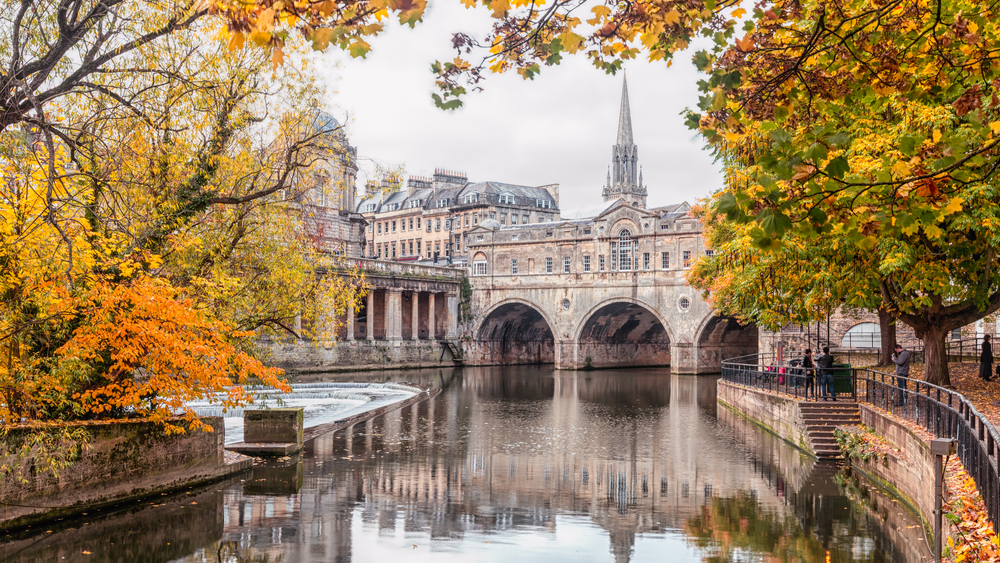 The city of bath in autumn showing the famous bridge and buildings. 