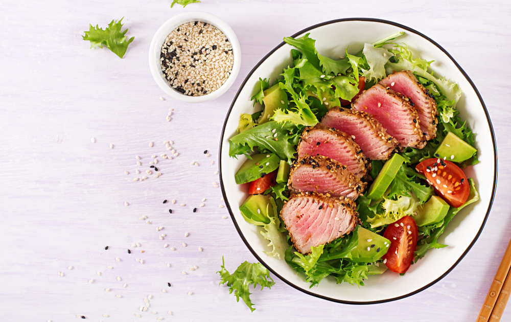 beautifully sesame covered, seared ahi tuna steaks over a salad, some of the best restaurants in san antonio have lovely ahi dishes like this one!