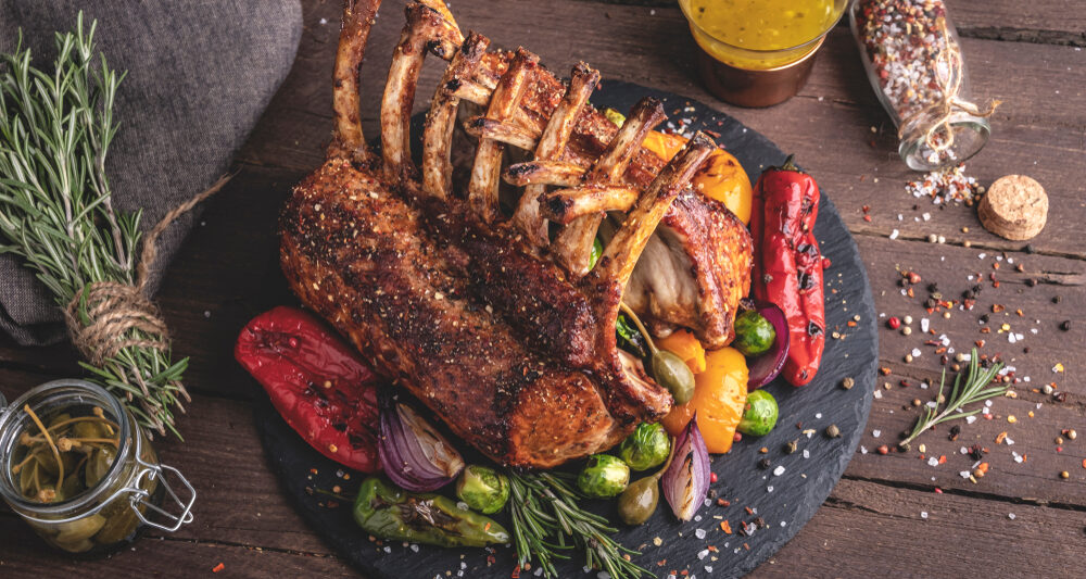 steal and vegetables on a black plate with brown background at a san antonio restaurant