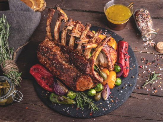 steal and vegetables on a black plate with brown background at a san antonio restaurant