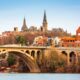 beautiful fall image of the bridge leading into the Georgetown district with lovely terracotta buildings and medieval-like structures on their campus!