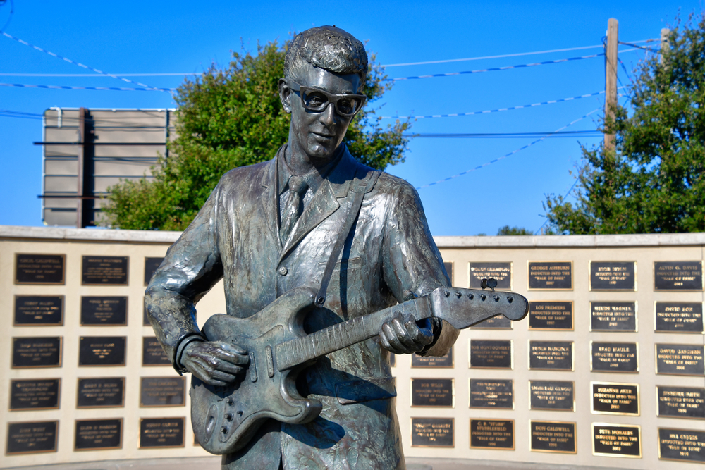 a statue of Buddy Holly in the down to Lubbock Texas. he is yound and playing the guitar 
