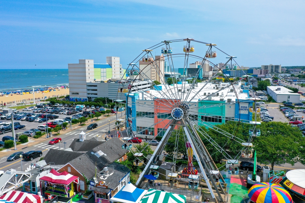 a beautiful Ferris wheel in the center of Virginia beach oceanfront with city in the background