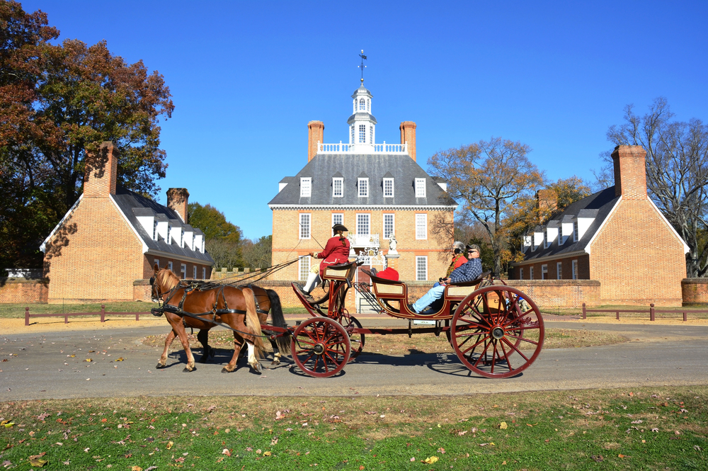 a horse drawn carriage in the center of historic williamsburg. this is one of the best weekend getaways in Virginia