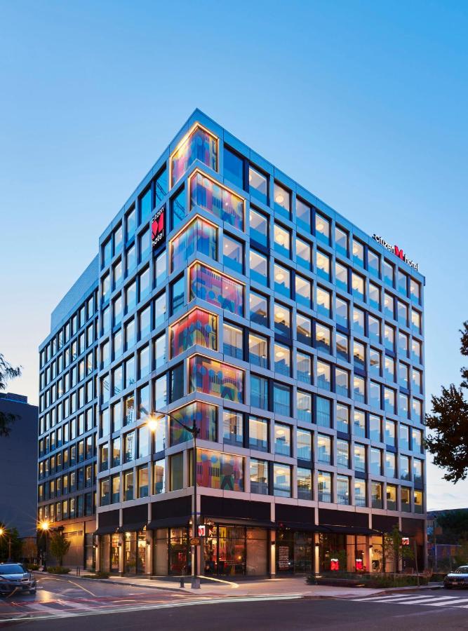 the outside of the CitizenM Washington DC NoMa neon windows on a busy street. this is one of the best places to stay during your weekend in Washington DC