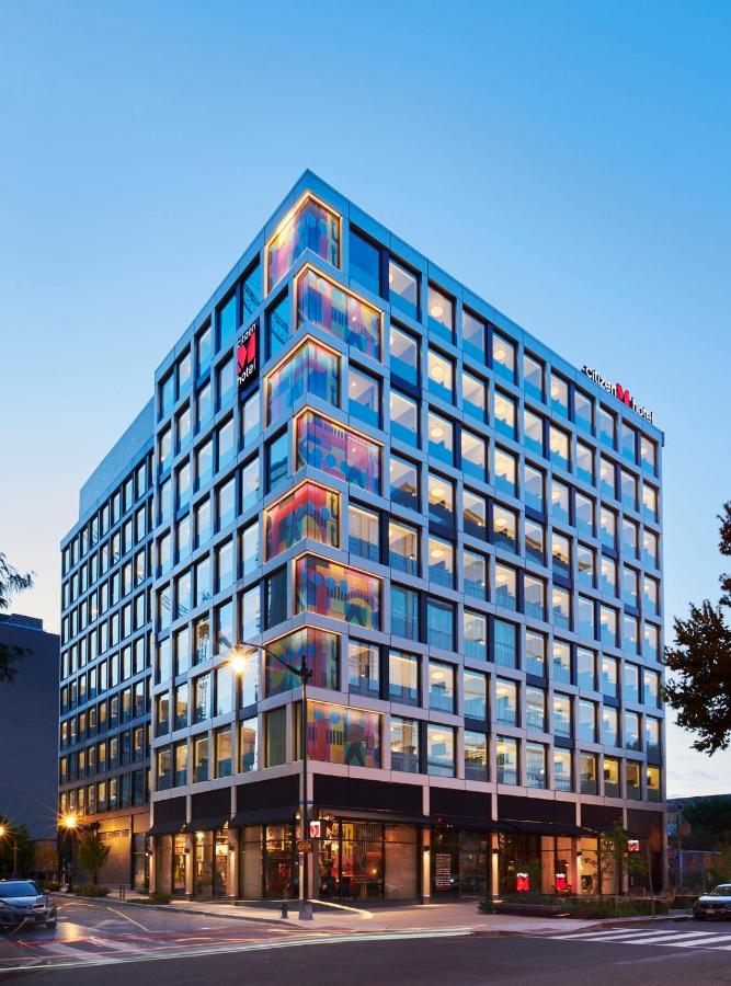 the outside of the CitizenM Washington DC NoMa neon windows on a busy street. this is one of the best places to stay during your weekend in Washington DC 