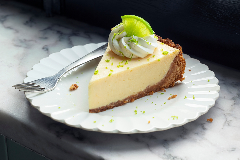 A perfect slice of key lime pie on a white plate